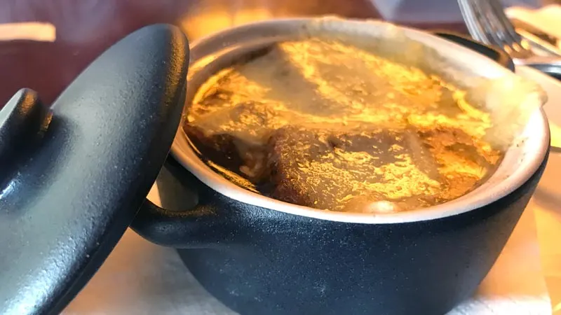 Classical French Onion Soup. Beef Broth, Julienne Onions, Melted Swiss and Gruyère Cheese with Croutons.