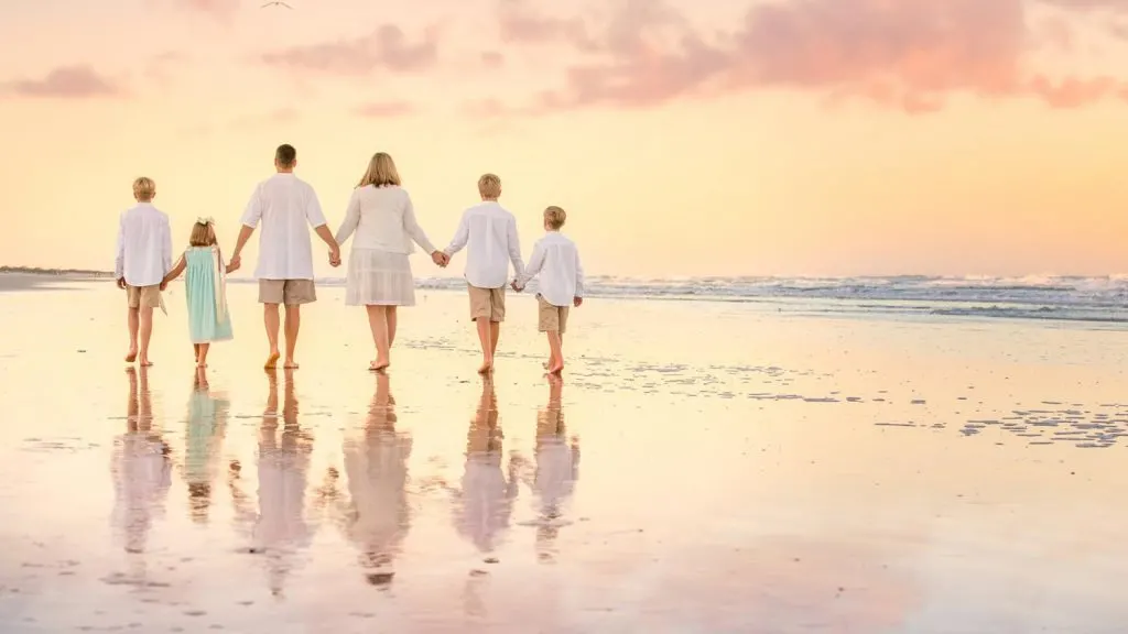 Sunset family walking on the beach